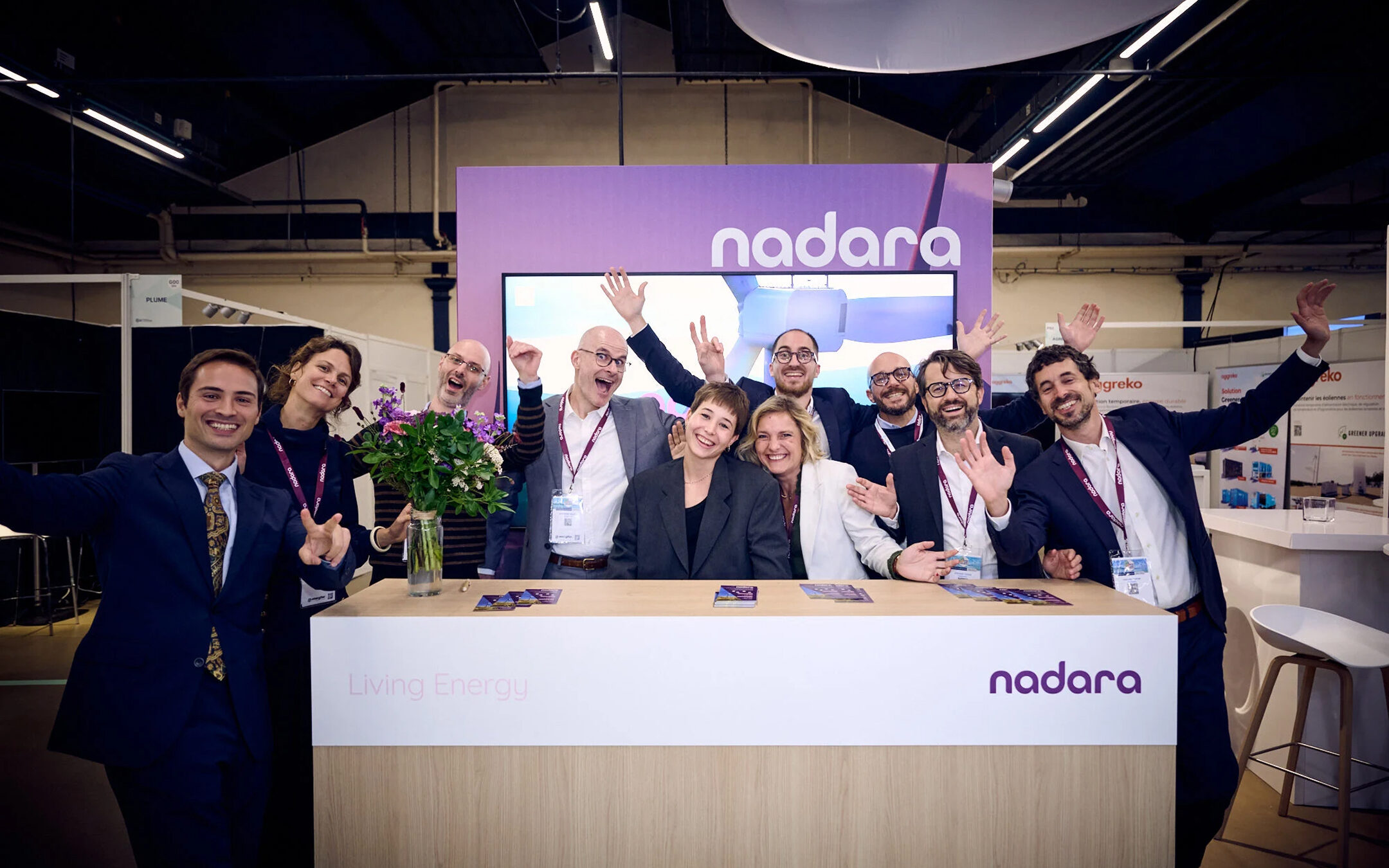 Members of the Nadara team posing for a photo at an event stand